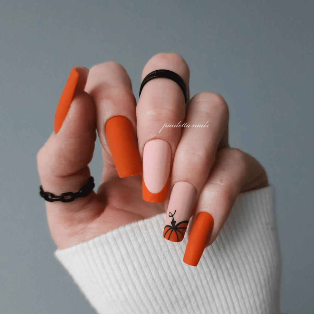 Close-up of Halloween-themed nails with detailed designs like Orange and Black: The Timeless Duo