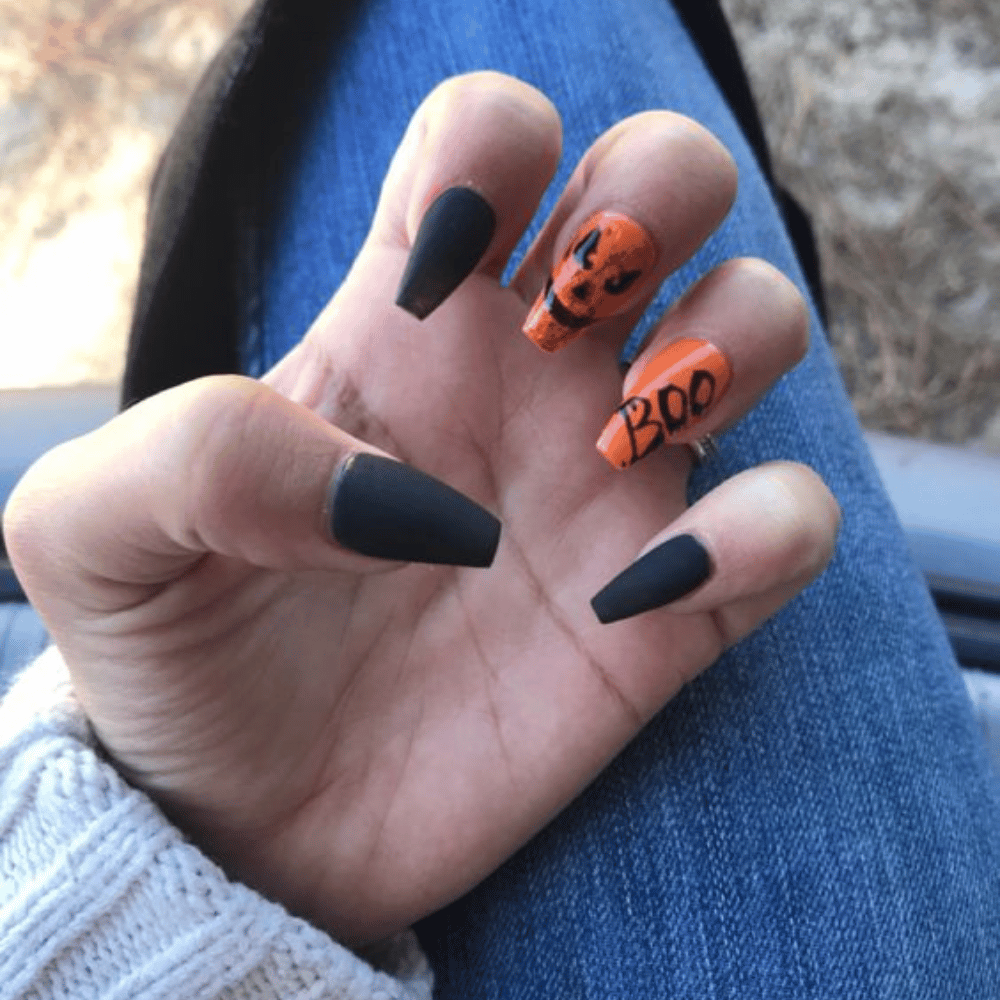 Close-up of Halloween-themed nails with detailed designs like All-Black Matte with Glossy Accents