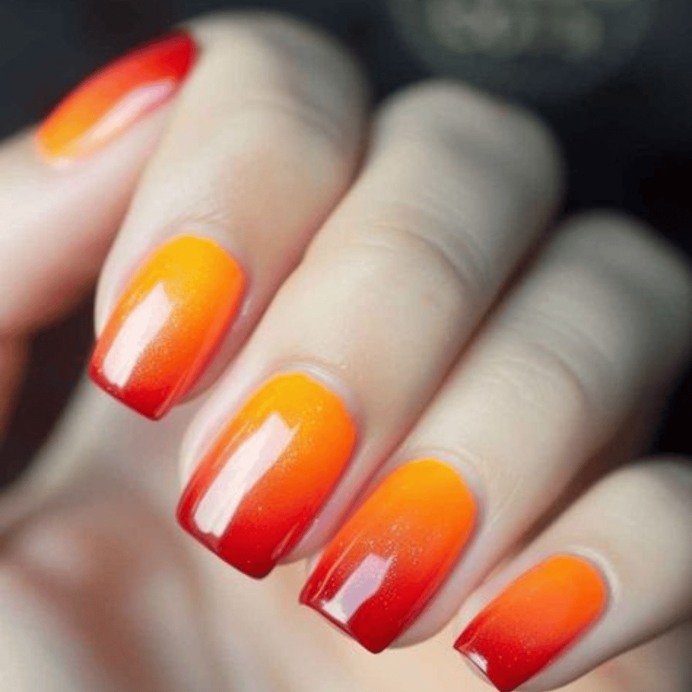 Close-up of hands with fall nail design having Sunset-Inspired Color Transitions