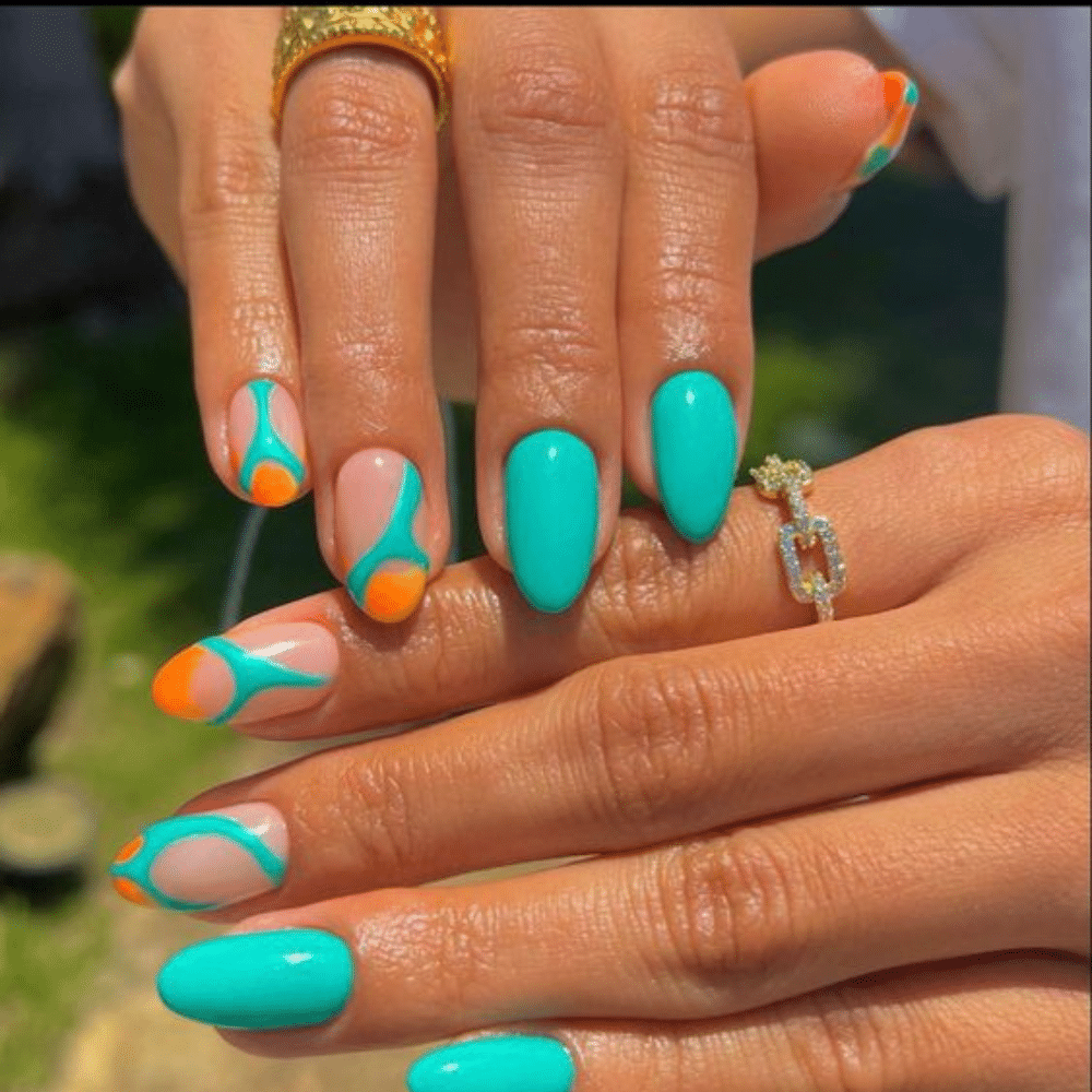 Close up of nails with glittery orange nails having Orange and Turquoise Combo