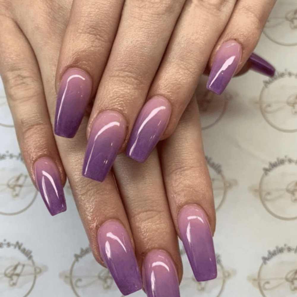 Close-up of hands having lavender nails with Ombre Effects