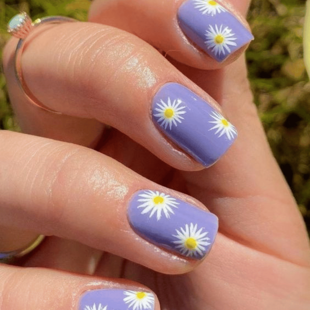 Close-up of hands having lavender nails with Spring Blooms