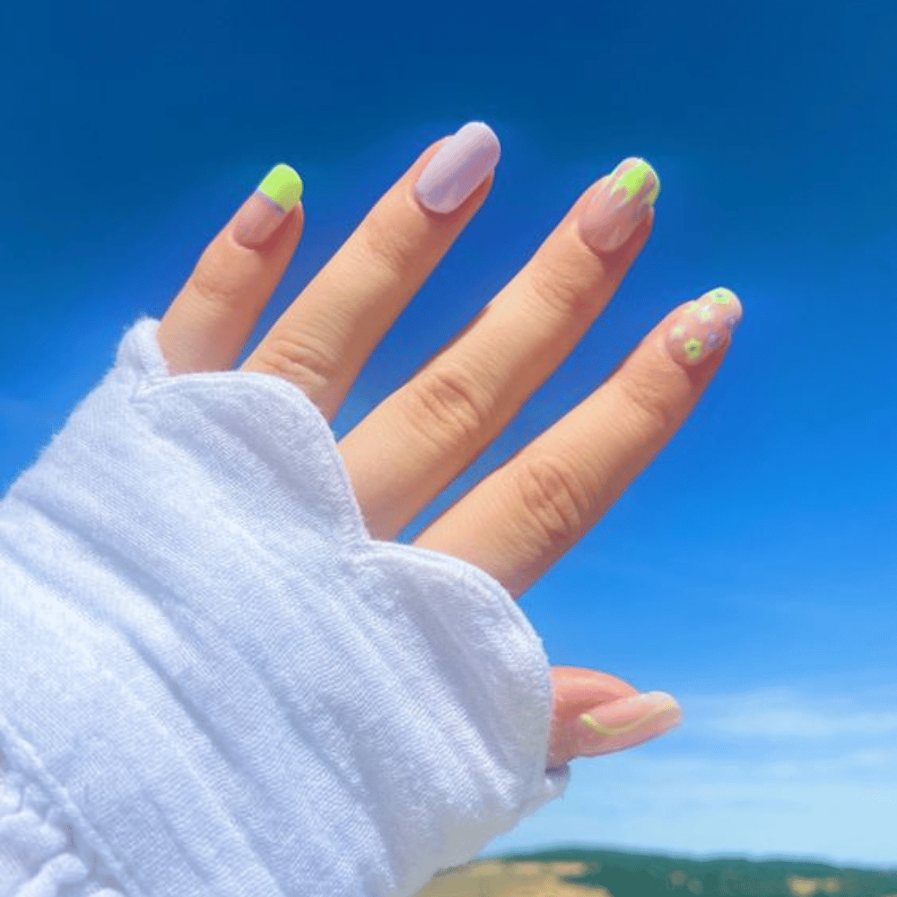 Close-up of hands having lavender nails with Summer Splash