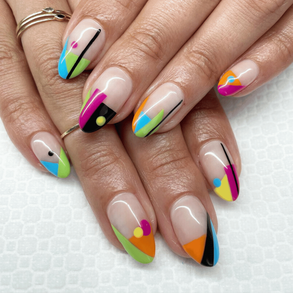 A collection of vibrant geometric nail art designs showcasing various colors and patterns on manicured nails.