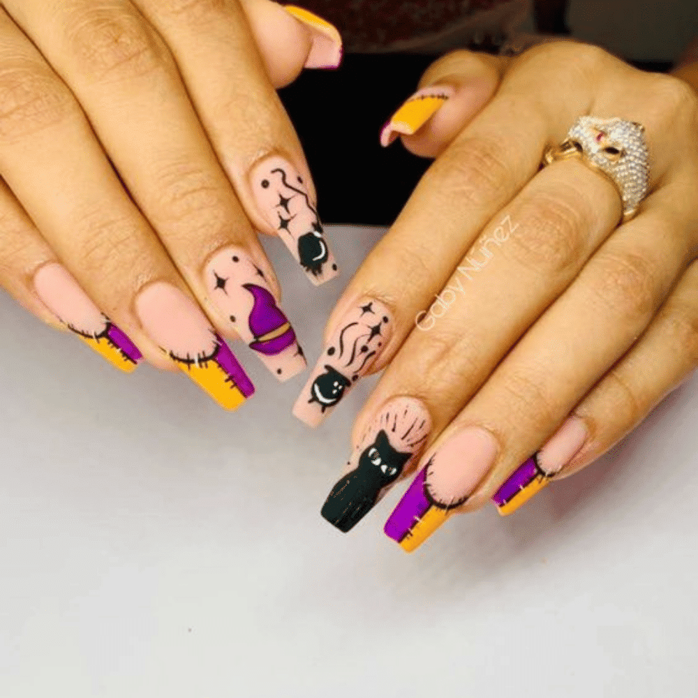 Close-up of Halloween-themed nails with detailed designs like "Hocus Pocus" Themed Nails