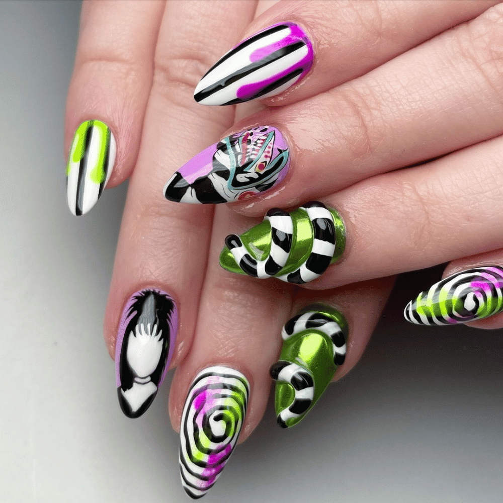 Close-up of Halloween-themed nails with detailed designs like "Beetlejuice" Striped Designs