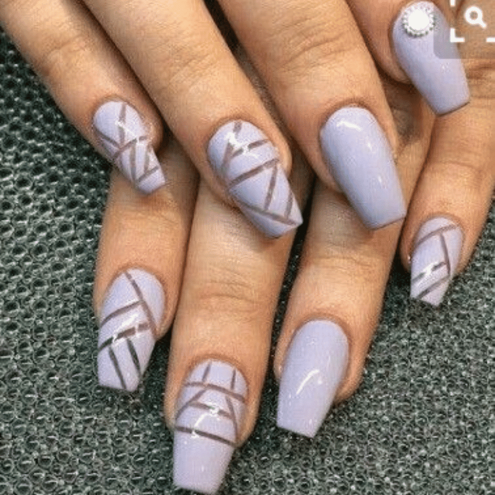 Close-up of hands having lavender nails with Negative Space Designs