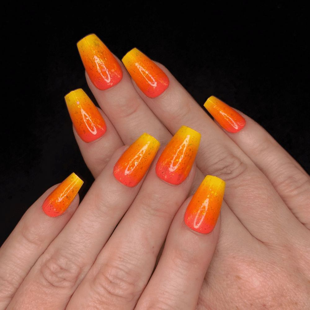 Close-up of Halloween-themed nails with detailed designs like Traditional Candy Corn Gradients