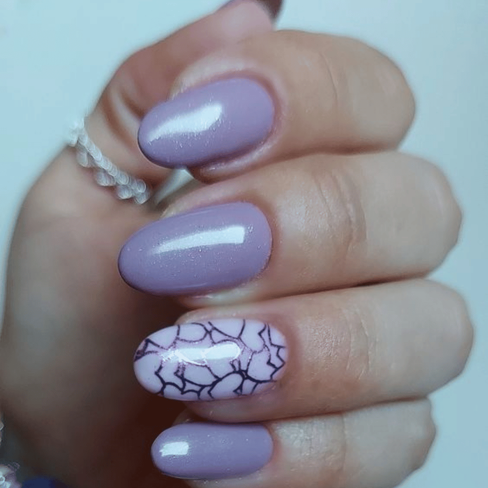 Close-up of hands having lavender nails with Stamping and Stenciling Patterns