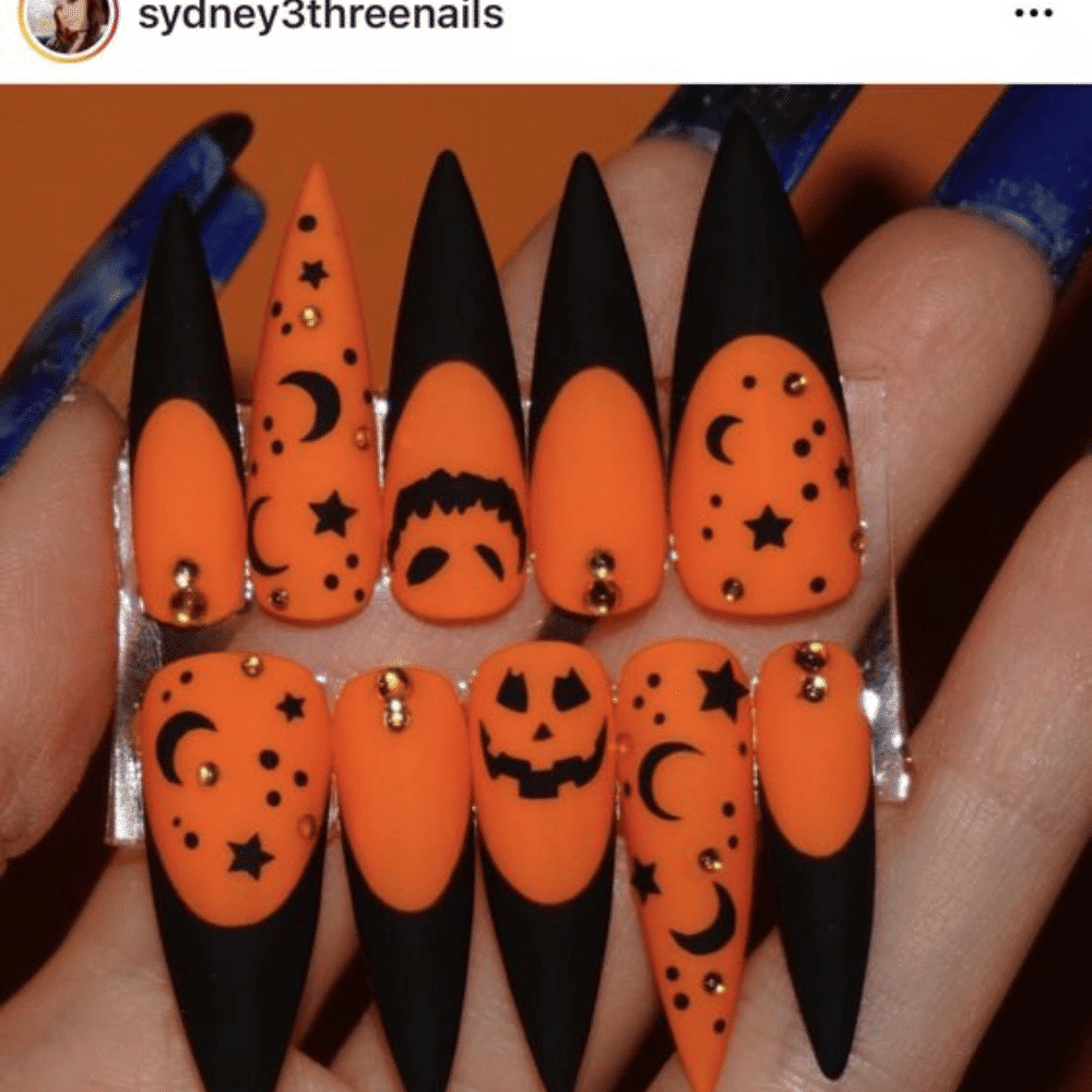 Close-up of Halloween-themed nails with detailed designs like Matte Orange with Metallic Details