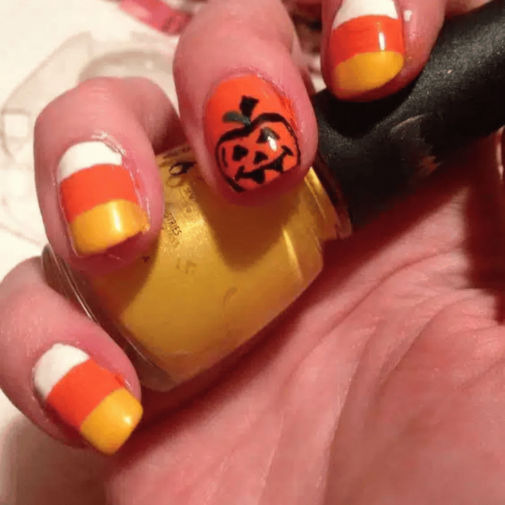 Close-up of Halloween-themed nails with detailed designs like Candy Corn Characters