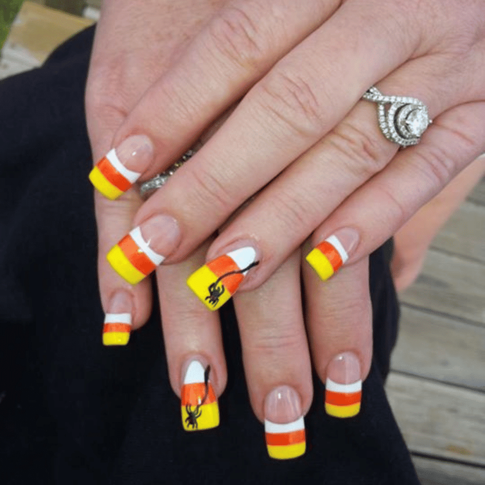 Close-up of Halloween-themed nails with detailed designs like Negative Space Candy Corn Art