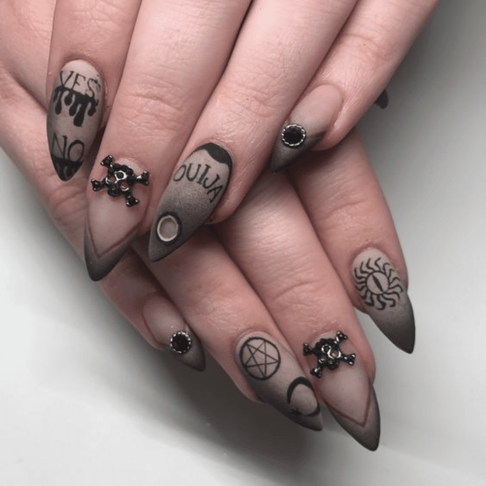 Close-up of Halloween-themed nails with detailed designs like Ouija Board Inspired Nails