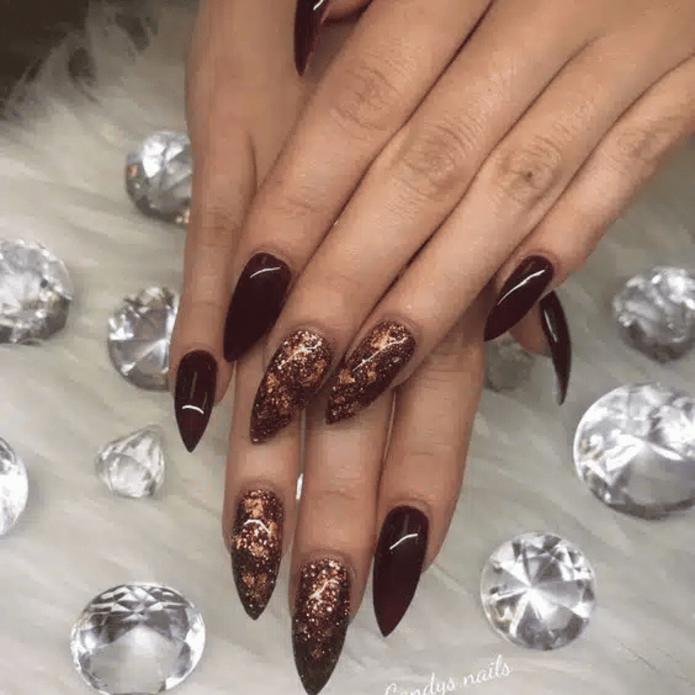 Close-up of hands with fall nail design having Copper Foil Designs