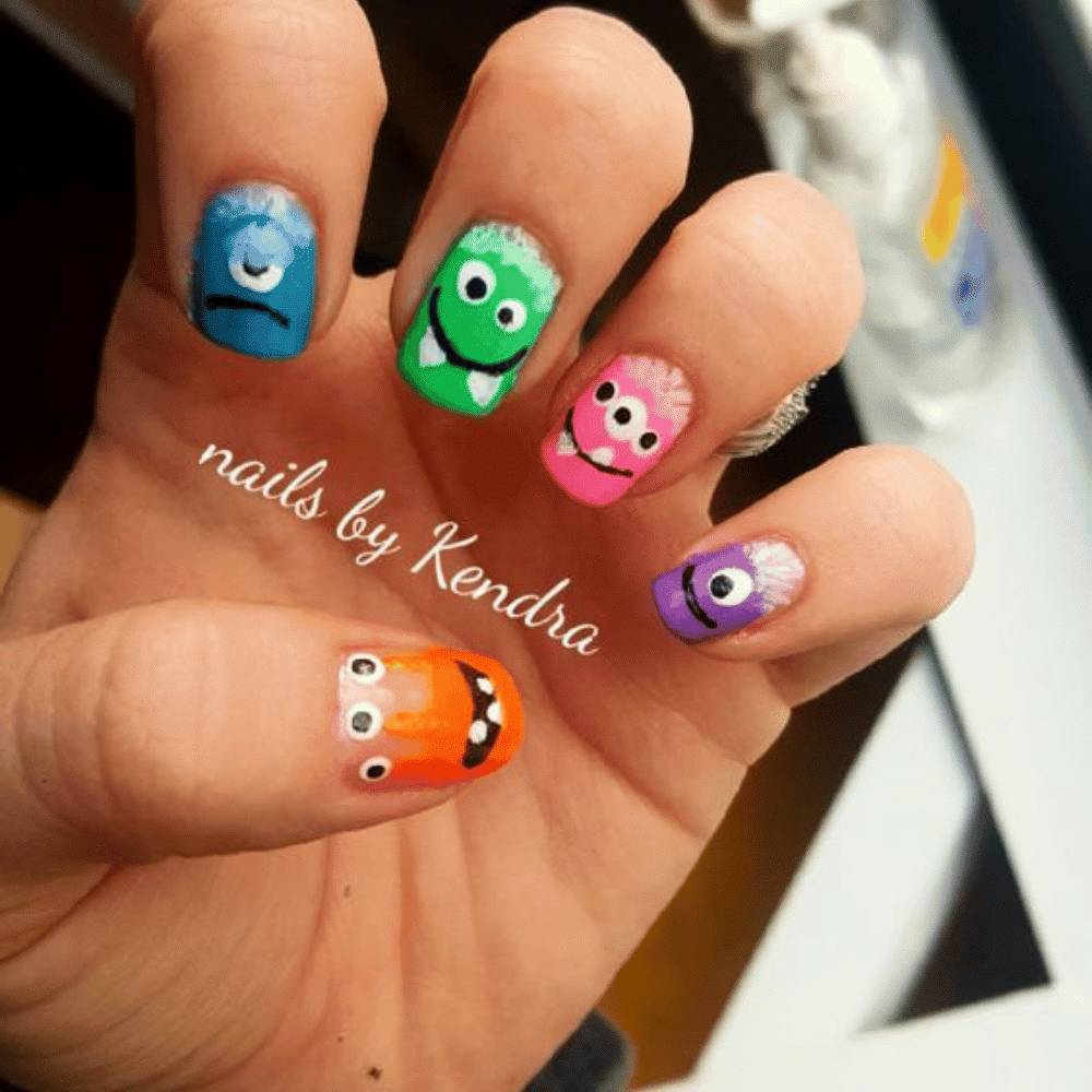 Close-up of Halloween-themed nails with detailed designs like Cute Monster Faces