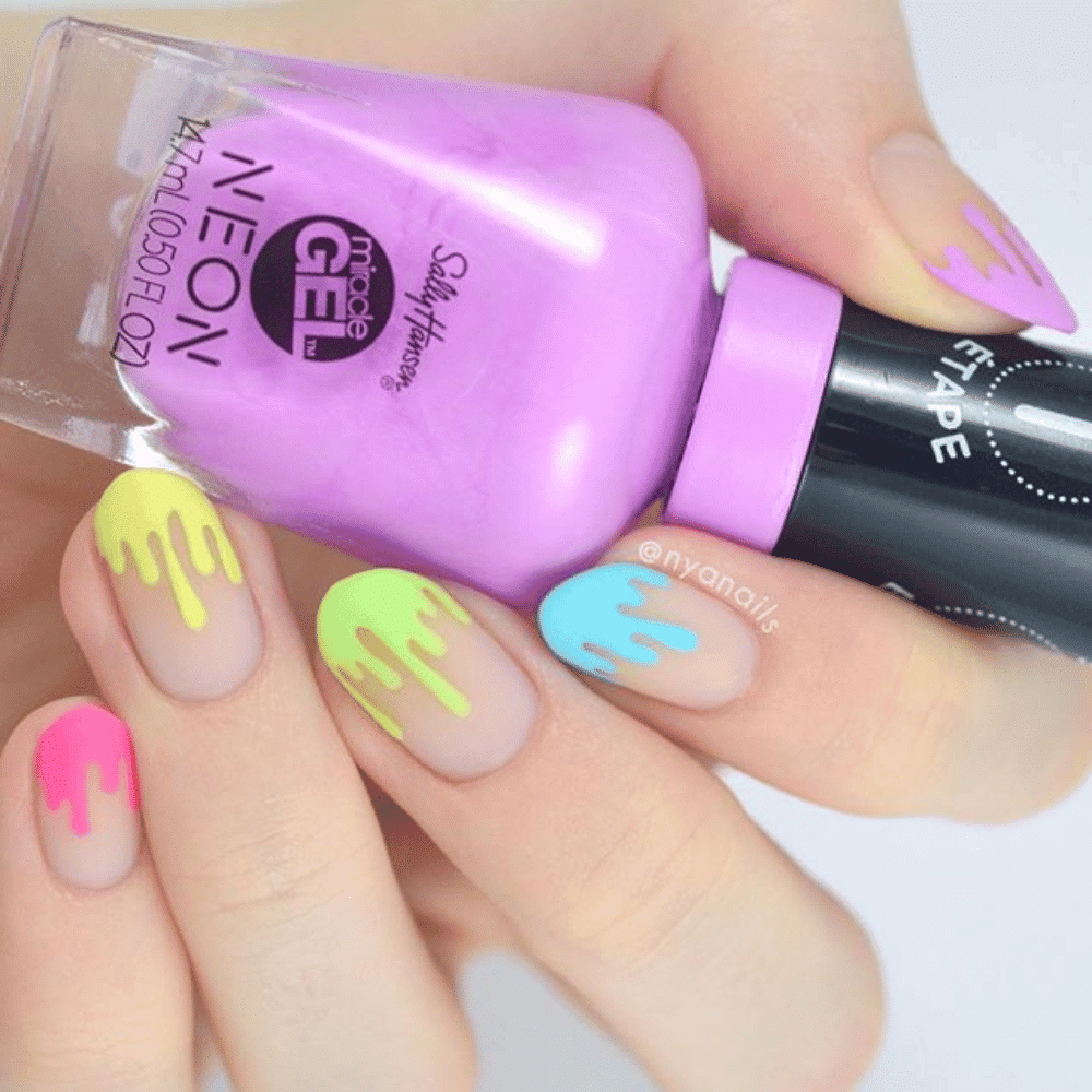 A person holds a purple and yellow nail polish bottle, with a vibrant neon pink drip cascading from the top.