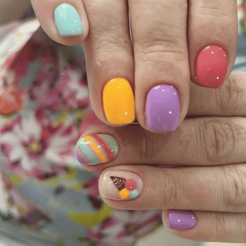 A vibrant display of nail art featuring intricate designs of colorful ice cream cones on each nail.