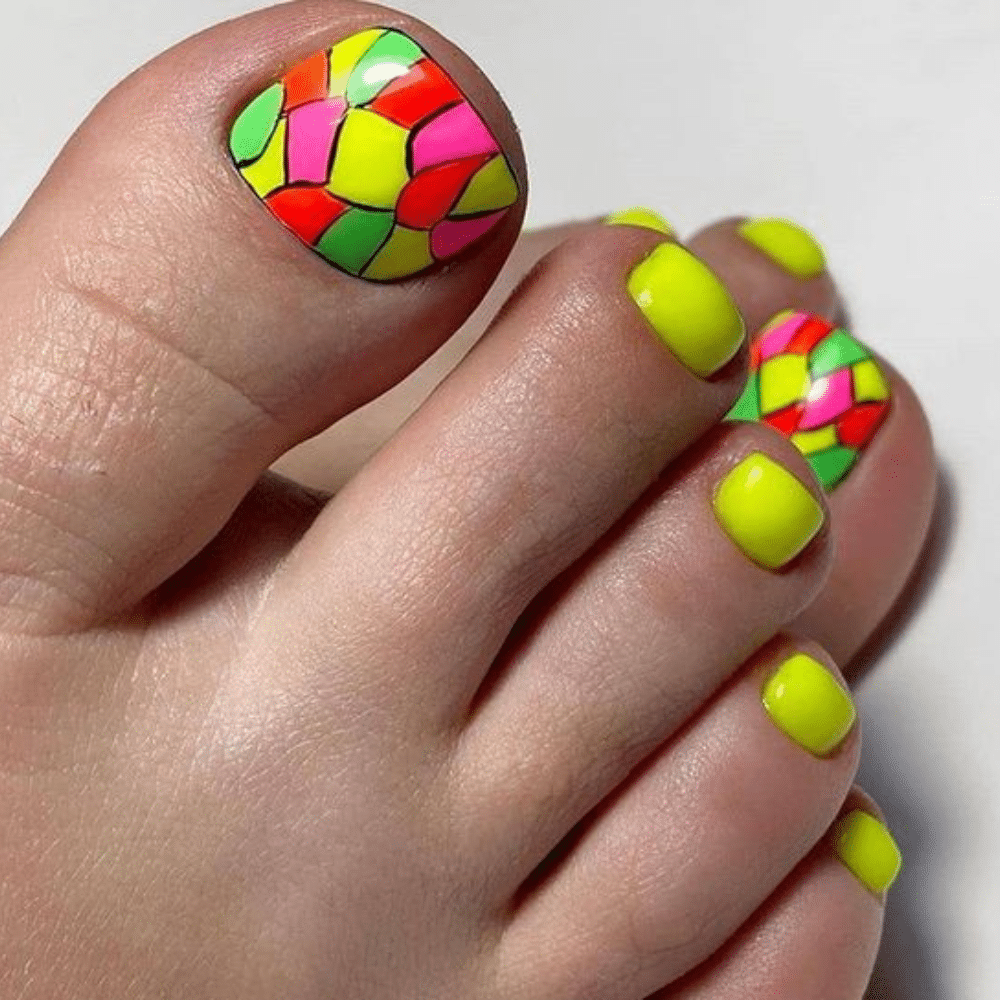 Close-up of toes with neon triangle toe nail