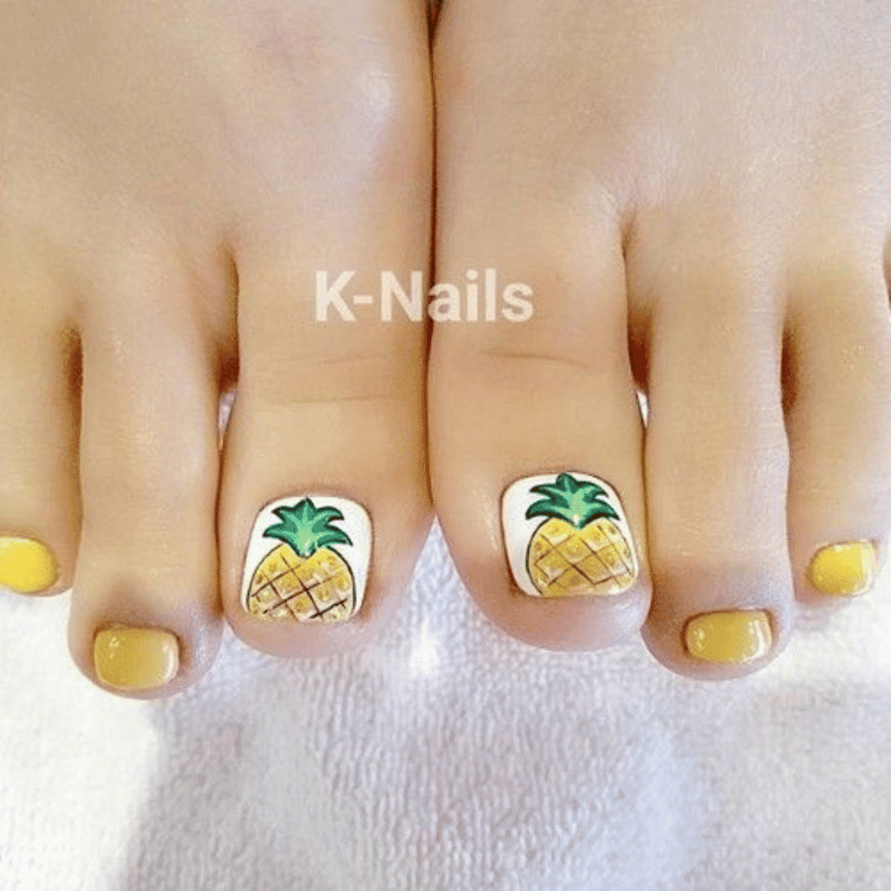 Close-up of toes with pineapple designed toe nails