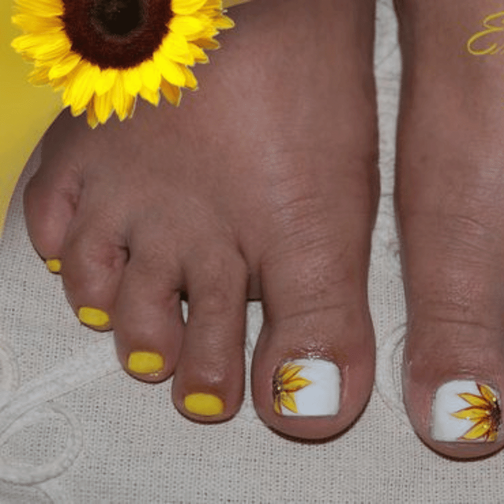 Close-up of toes with sunflower designed toe nail