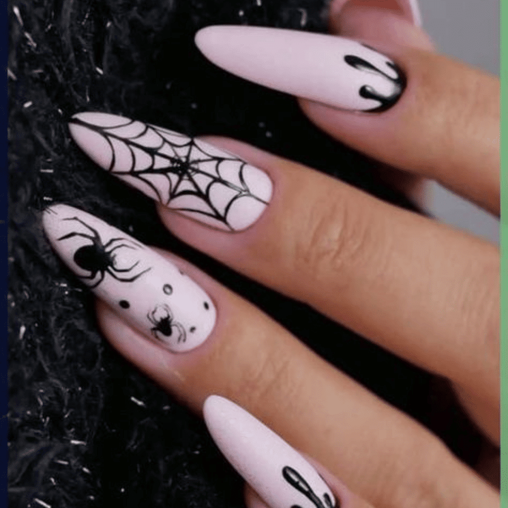 Close-up of a hand with long, almond-shaped nails featuring Halloween-themed designs with spider webs, spiders, and dripping paint.