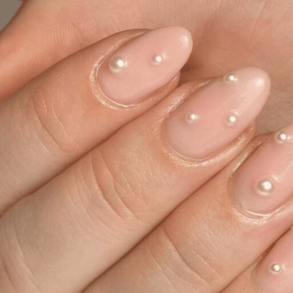 A close-up of a woman's hand adorned with elegant pearls, showcasing a refined and sophisticated accessory choice.