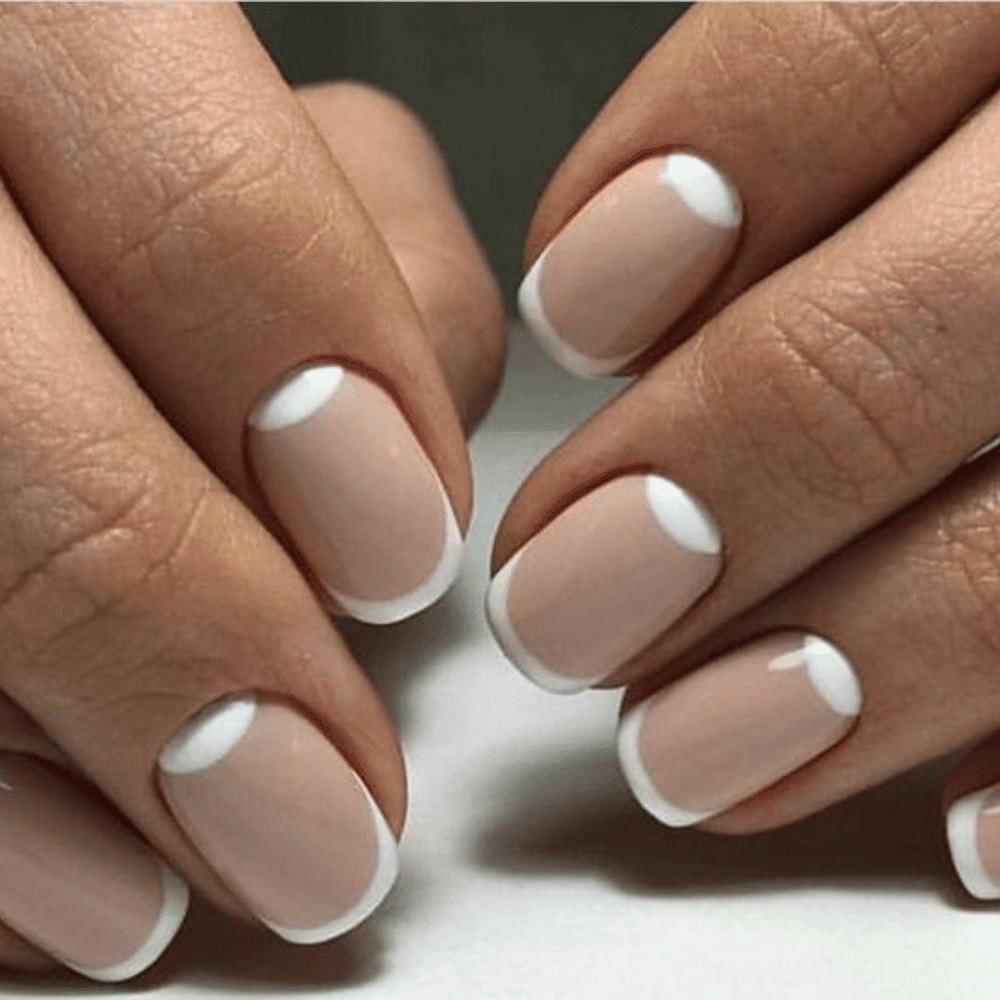 Close-up of hands with fall nail design having Reverse French with Autumn Hues