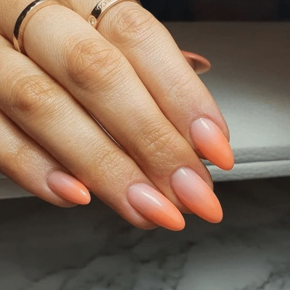 Close up of nails with glittery orange nails having Peach to Orange Transition