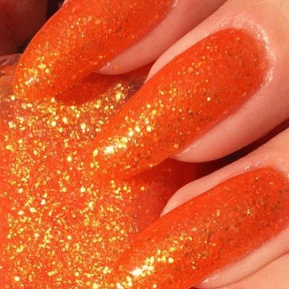 Close up of nails with glittery orange nails having Glitter Orange Nails