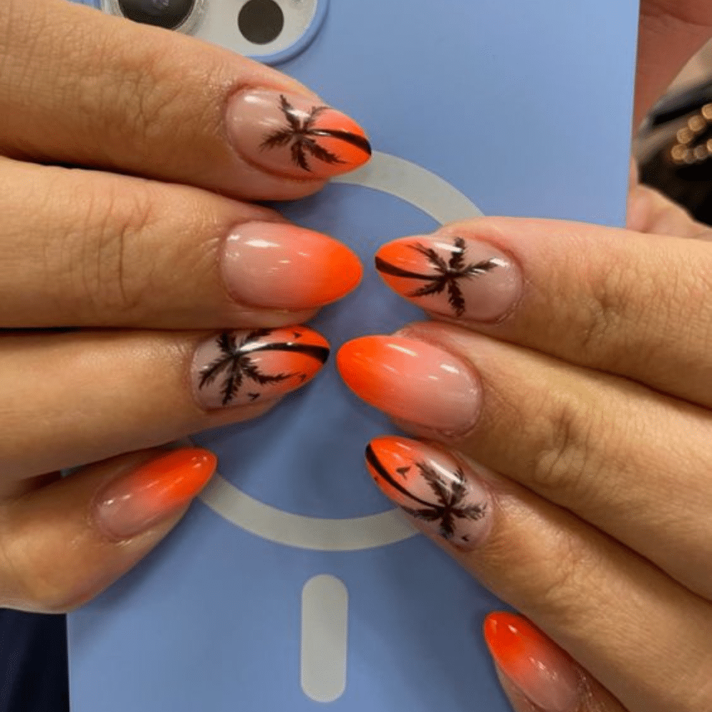 Close up of nails with glittery orange nails having Beach-Ready Orange Palm Tree Nails