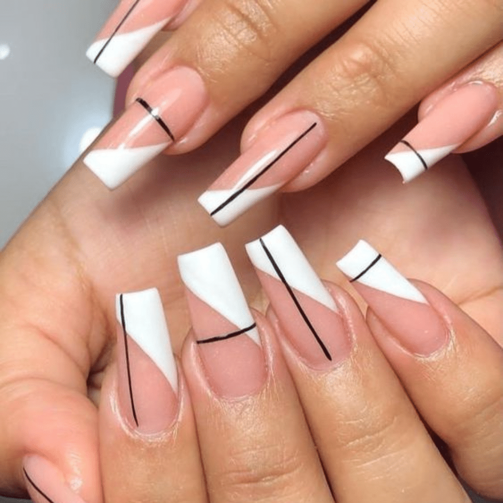 Close-up of a hand with white French tip Abstract Accent nail