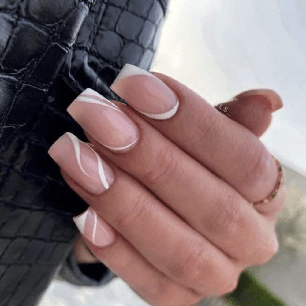 Close-up of a hand with white French tip Minimalist Lines nail