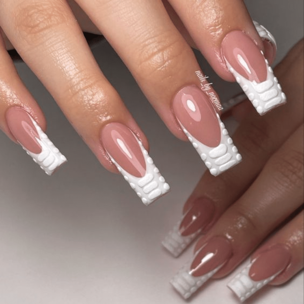 Close-up of a hand with white French tip Velvet Touch nail