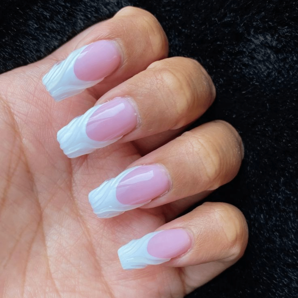 Close-up of a hand with white French tip 3D Effect nail