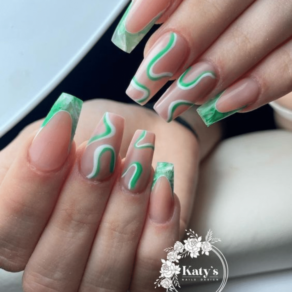 Close-up of a hand with white French tip nail with swirl sensation