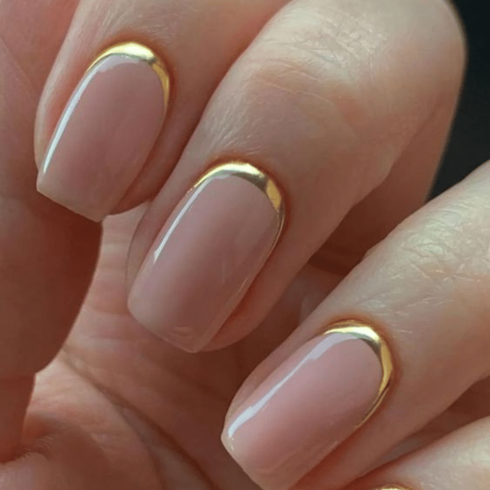 Close-up of a hand with white reverse french tip nail