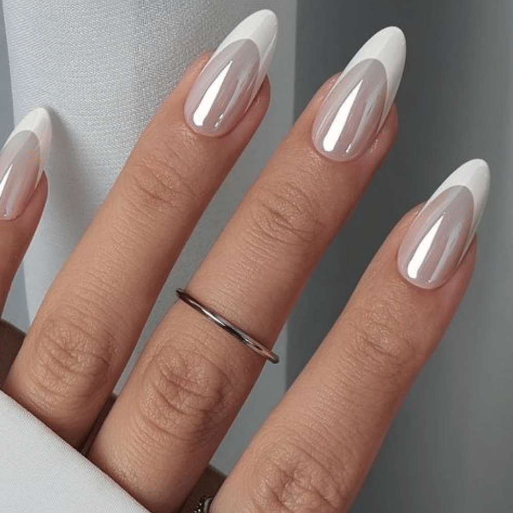 Close-up of a hand with white French tip Chrome Finish nail