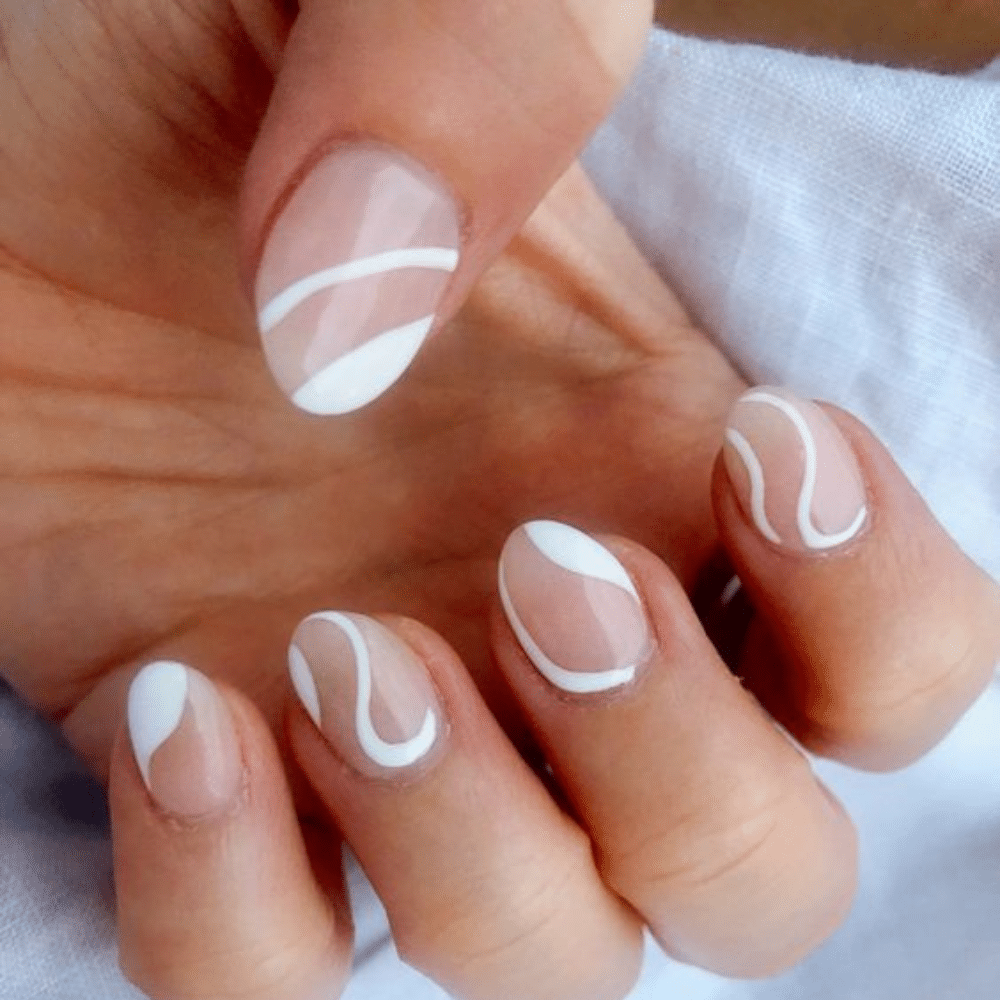 Close-up of a hand with white French tip Negative Space Art nail