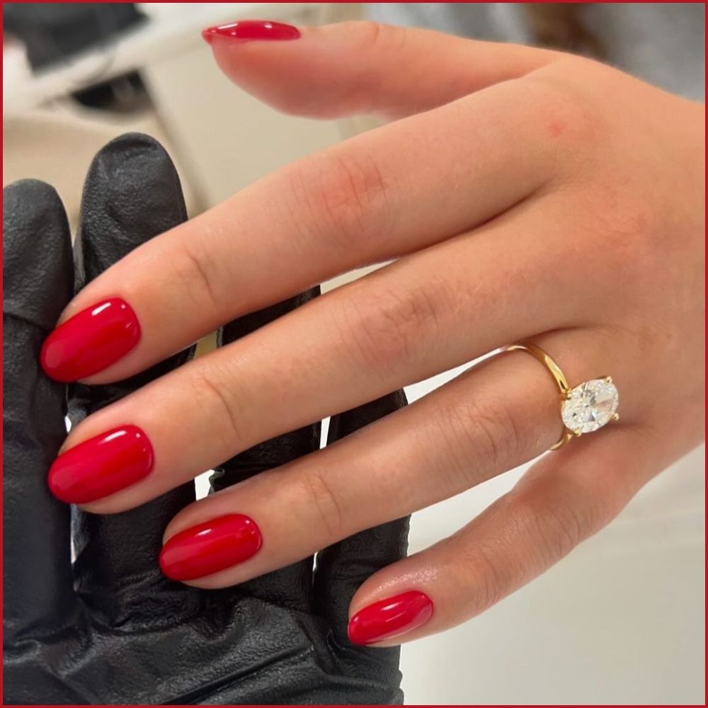 Close up of hands having Christmas red nails with Timeless Red Elegance Timeless Red Elegance