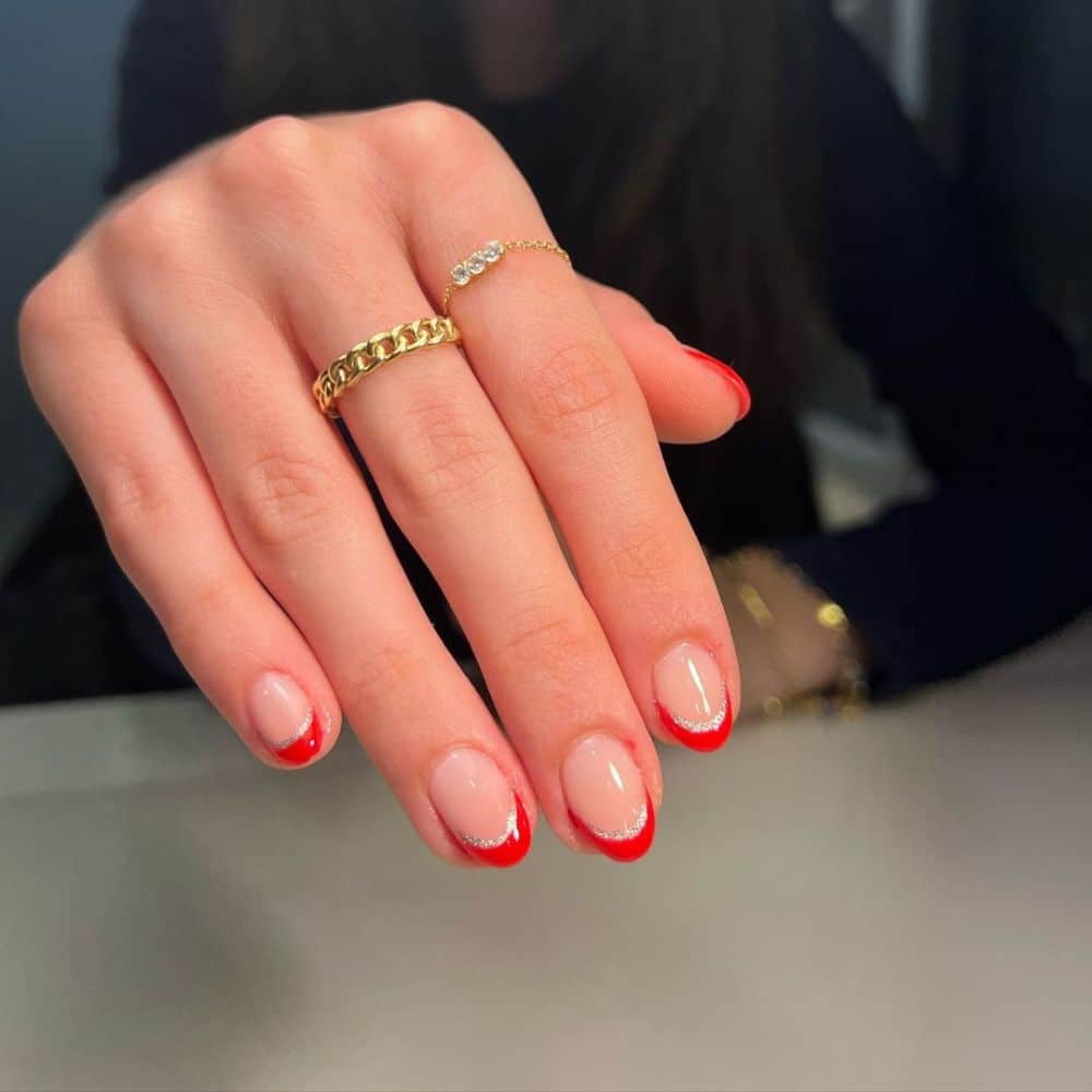 Close up of hands having Christmas red nails with Classy Red French